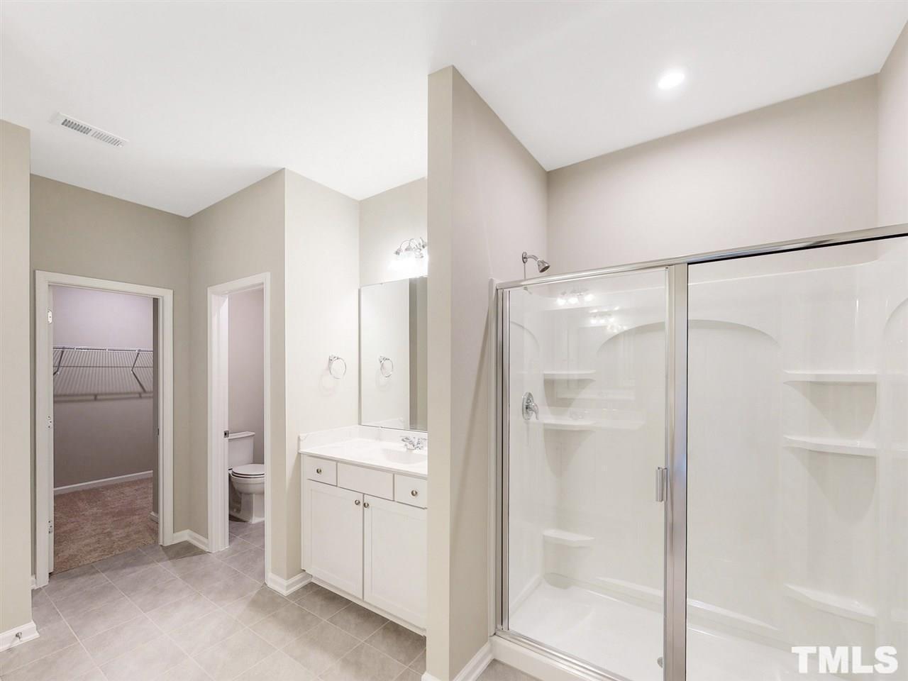 1605 Brussels Drive Apex, NC 27502 - Photo 8 of 17 a bathroom with a shower and a glass door