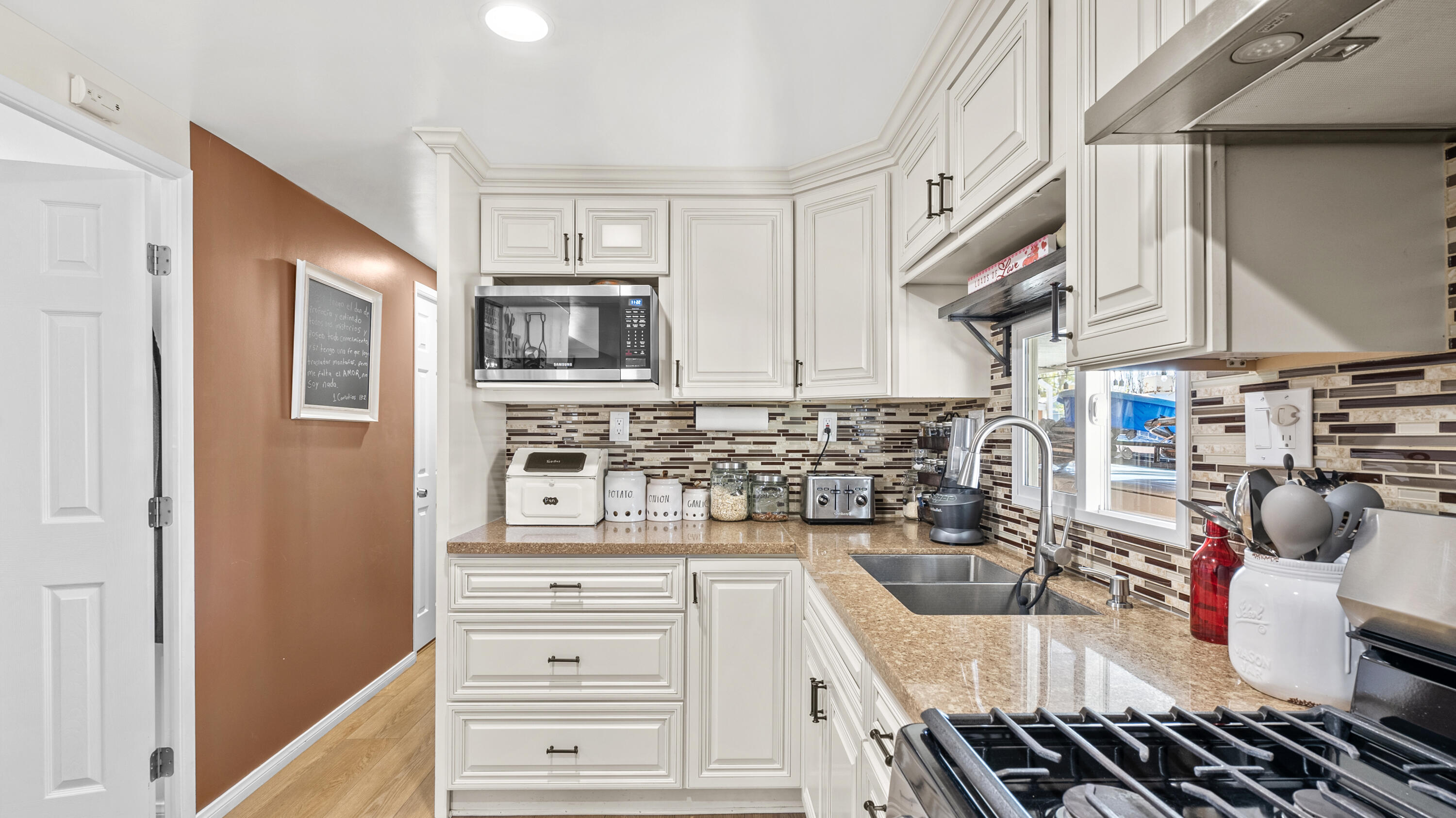 18035 Soledad Canyon Road Santa Clarita, CA 91387 - Photo 11 of 20 a kitchen with stainless steel appliances a stove microwave and cabinets