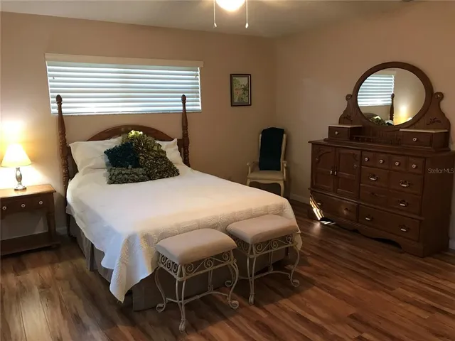 a bedroom with a bed and a dresser