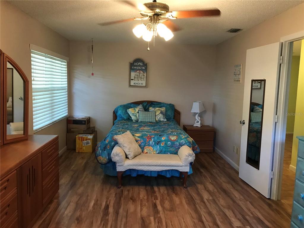 9257 Southwest 82nd Terrace, Unit H Ocala, FL 34481 - Photo 7 of 24 a living room with furniture and a wooden floor