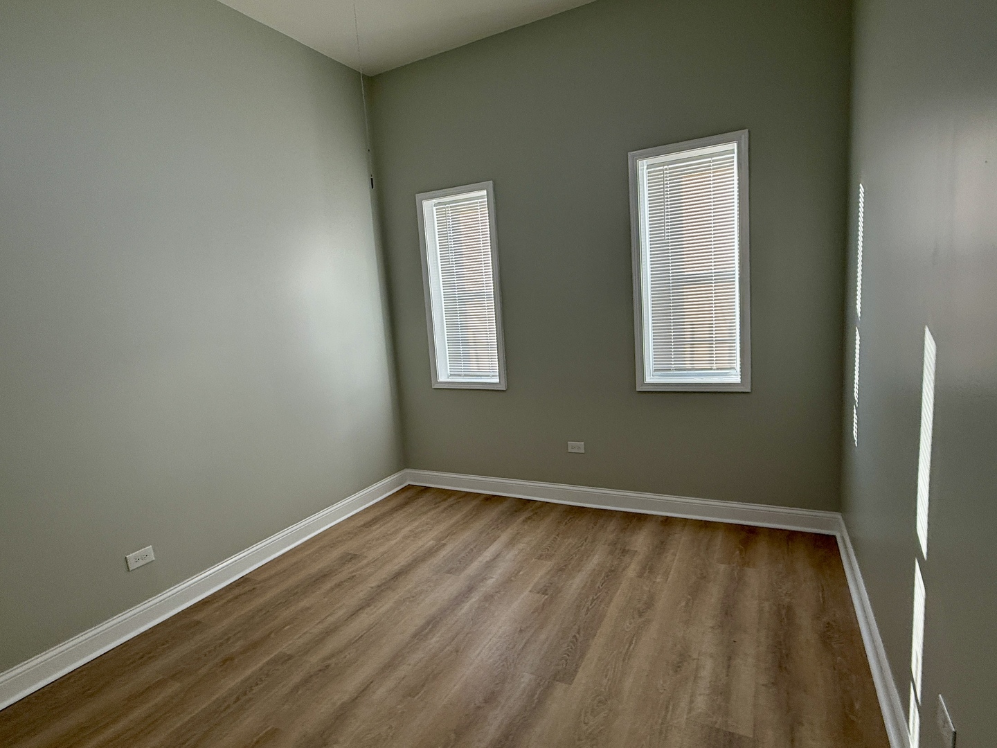 2003 South Allport Street, Unit 1 Chicago, IL 60608 - Photo 12 of 15 an empty room with wooden floor and windows
