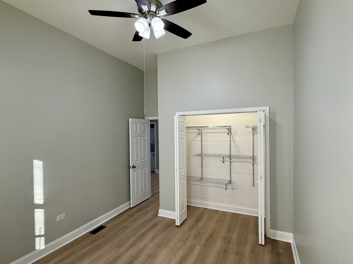 2003 South Allport Street, Unit 1 Chicago, IL 60608 - Photo 15 of 15 an empty room with wooden floor cabinet and a ceiling fan