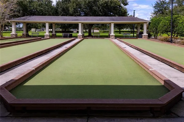 a view of swimming pool with outdoor seating and a garden