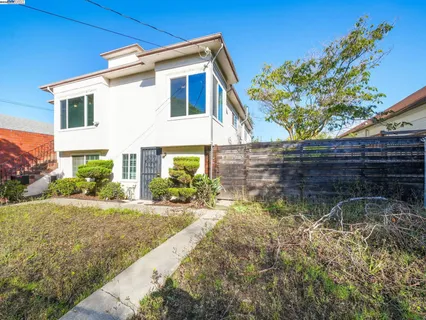 a kitchen with a sink dishwasher stove and wooden cabinets