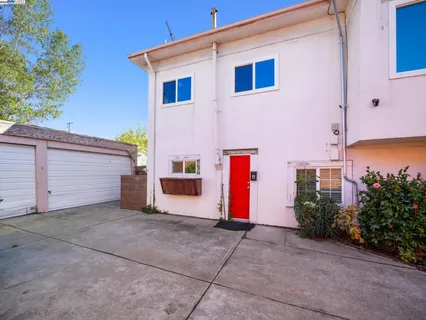 a spacious bedroom with a bed and a large window