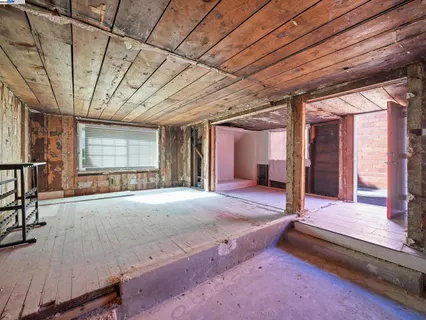 a view of a hallway with wooden roof and stairs