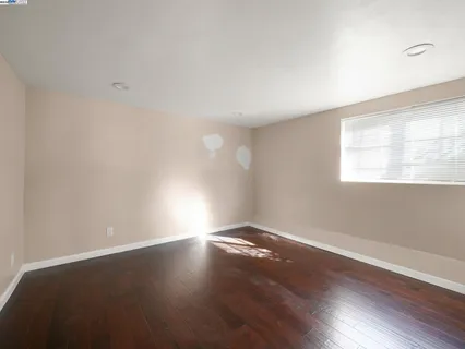 a view of room with window and wooden floor