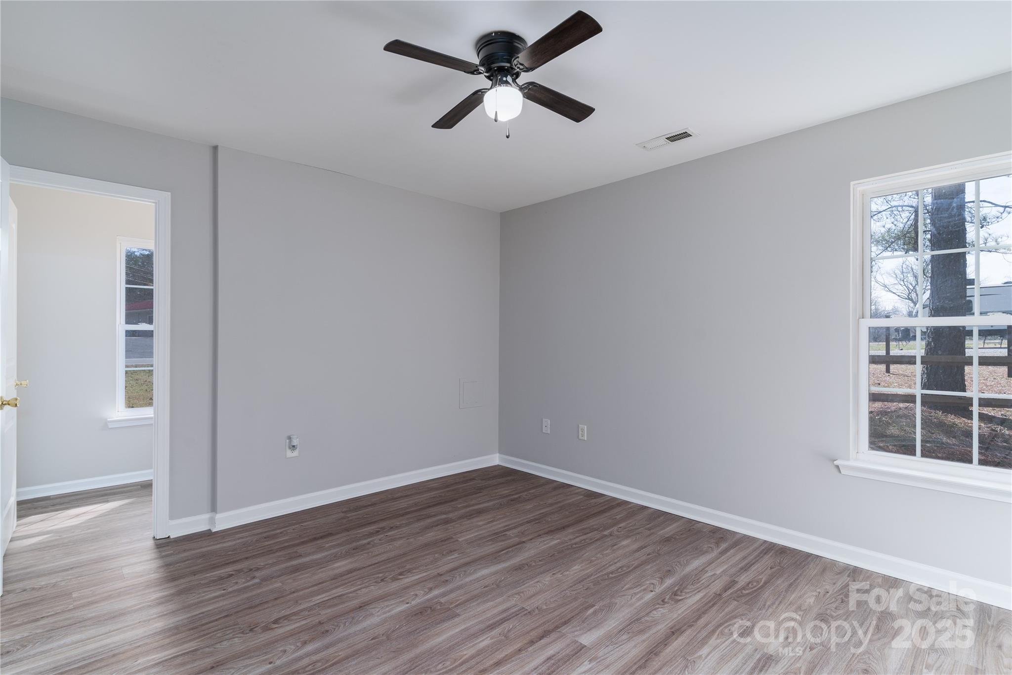1969 Beth Haven Church Road Denver, NC 28037 - Photo 18 of 33 a view of a room with wooden floor and a ceiling fan