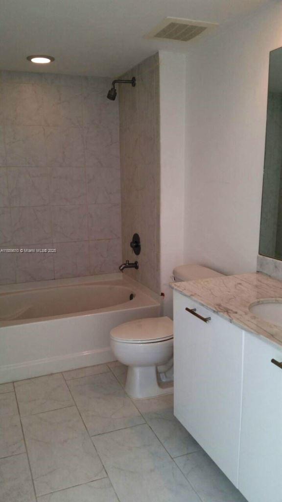 951 Brickell Avenue, Unit 3609 Miami, FL 33131 - Photo 14 of 25 a bathroom with a granite countertop toilet a sink and bathtub