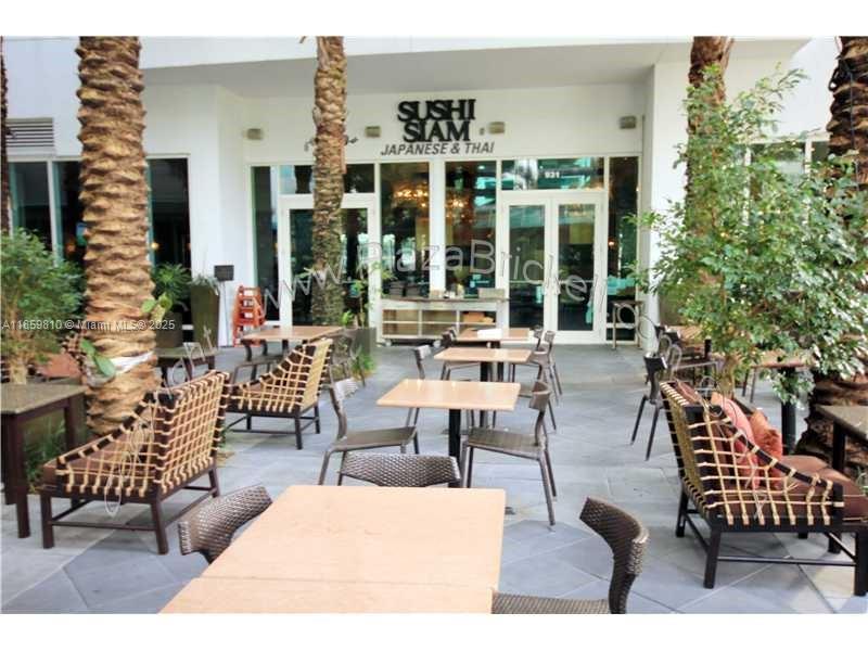 951 Brickell Avenue, Unit 3609 Miami, FL 33131 - Photo 24 of 25 a building outdoor space with patio furniture and potted plants
