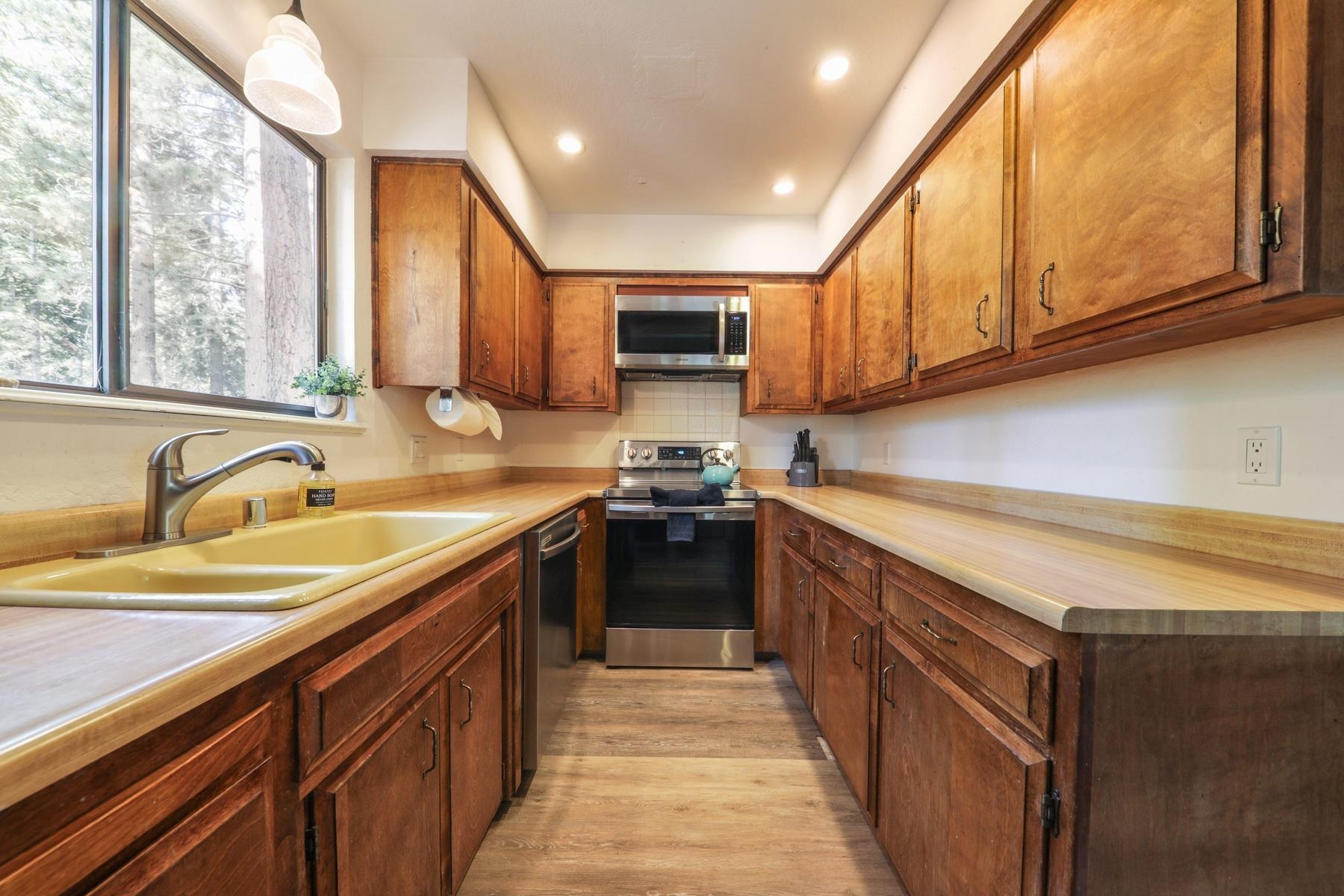 5656 Victoria Road Carnelian Bay, CA 96140 - Photo 14 of 28 a kitchen with stainless steel appliances granite countertop a stove a sink and a microwave