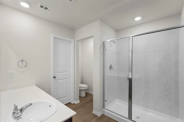 a bathroom with a shower and a sink