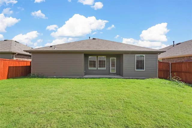 a view of a house with a backyard
