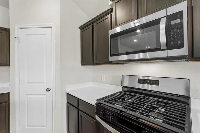 a kitchen with a stove and a microwave