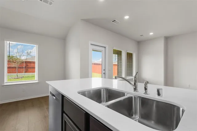 a kitchen with a sink and a window