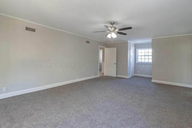 a view of an empty room with a window