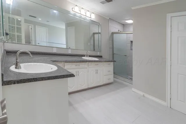 a bathroom with a sink double vanity and a mirror