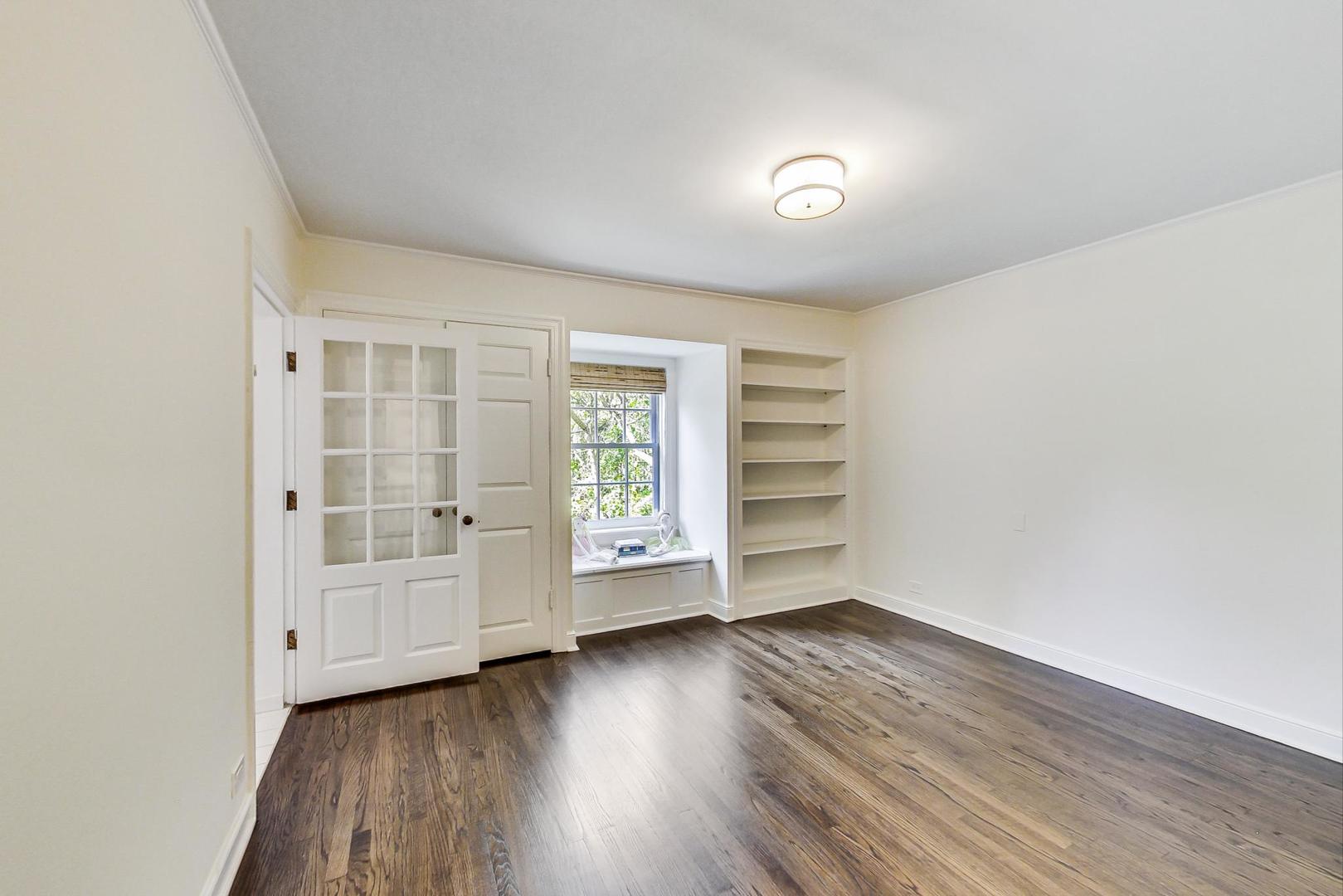 110 Sheridan Road Winnetka, IL 60093 - Photo 24 of 41 wooden floor in an empty room with a window