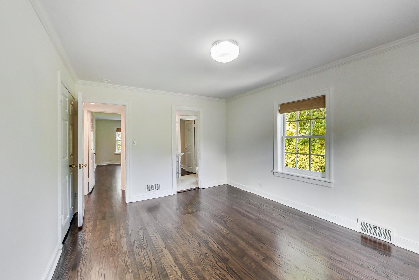 110 Sheridan Road Winnetka, IL 60093 - Photo 27 of 41 a view of an empty room with window and wooden floor