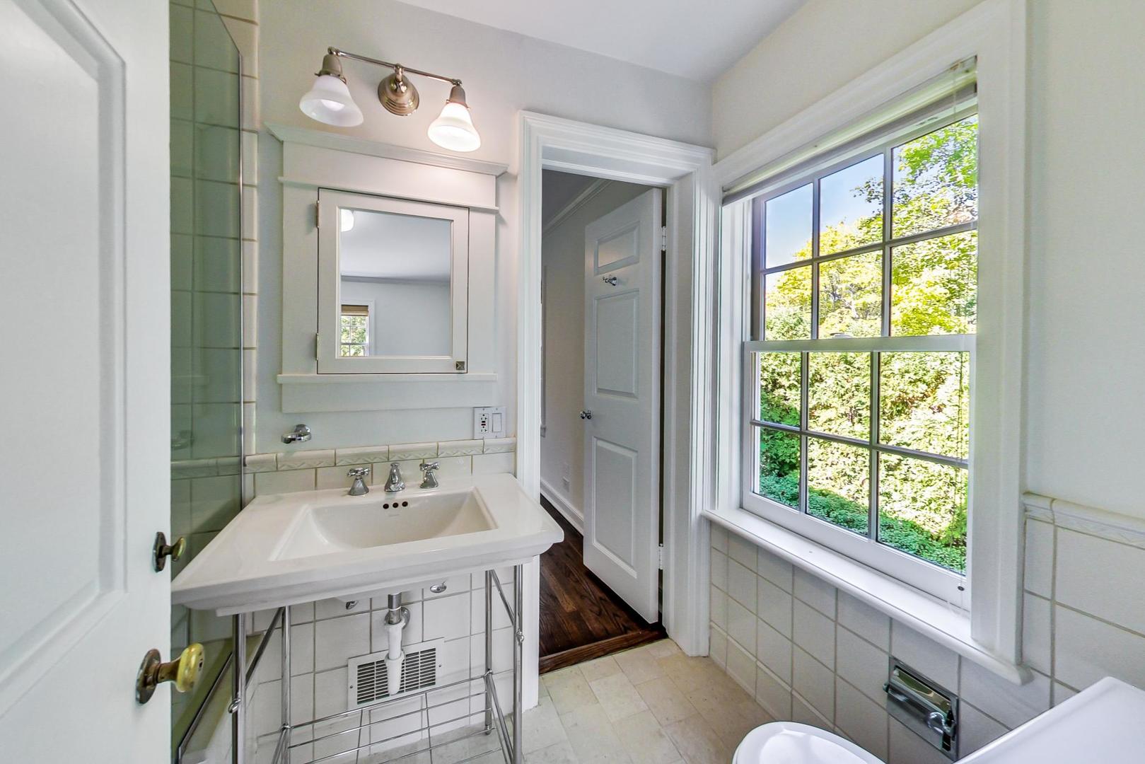110 Sheridan Road Winnetka, IL 60093 - Photo 28 of 41 a bathroom with a sink and a mirror