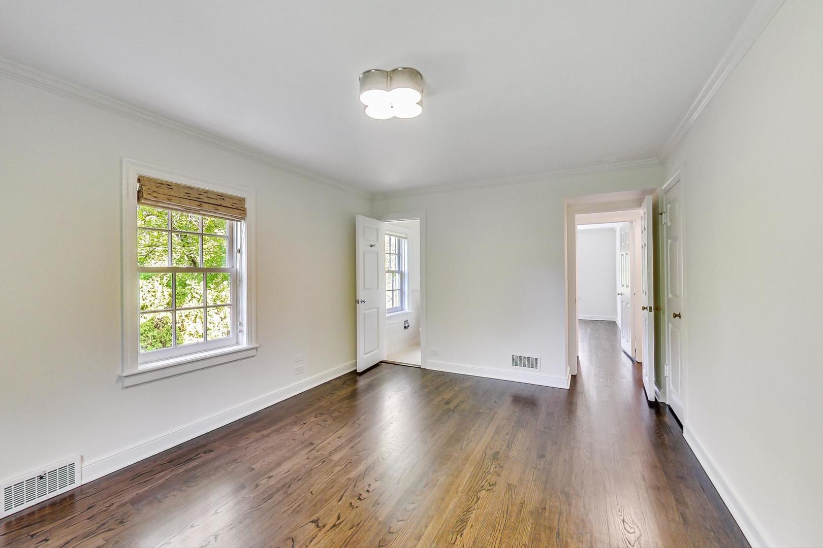 110 Sheridan Road Winnetka, IL 60093 - Photo 29 of 41 an empty room with wooden floor and windows