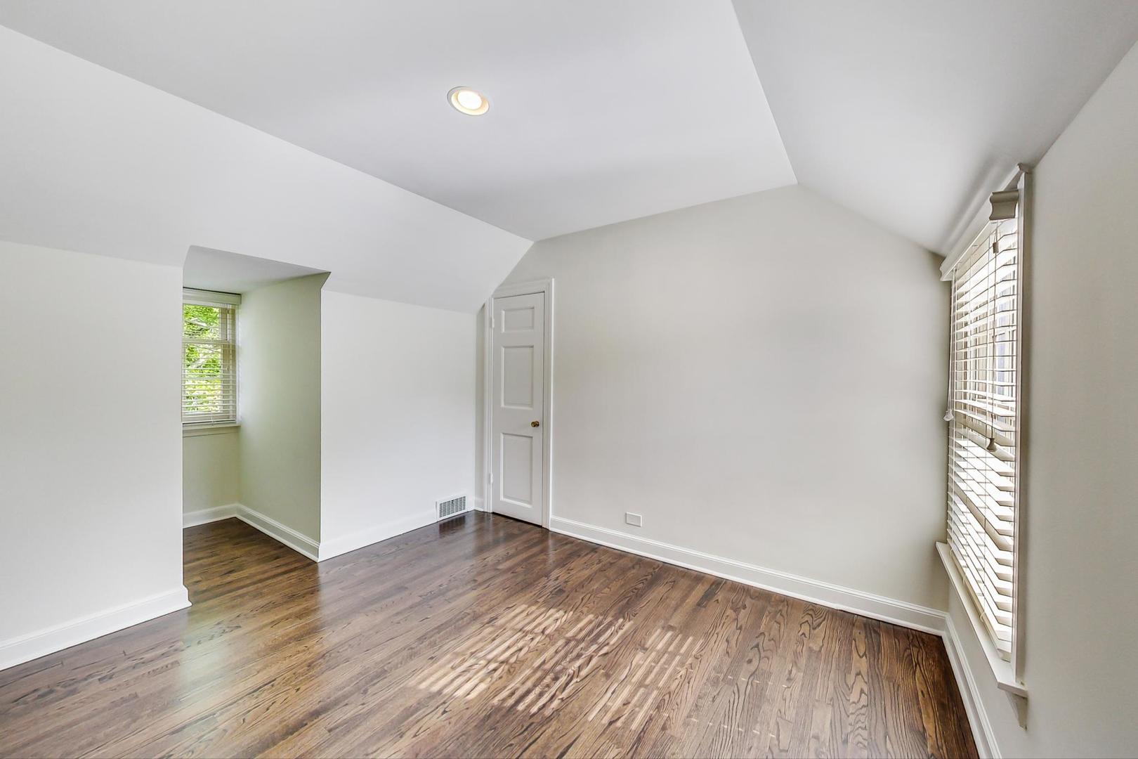110 Sheridan Road Winnetka, IL 60093 - Photo 31 of 41 an empty room with wooden floor and windows