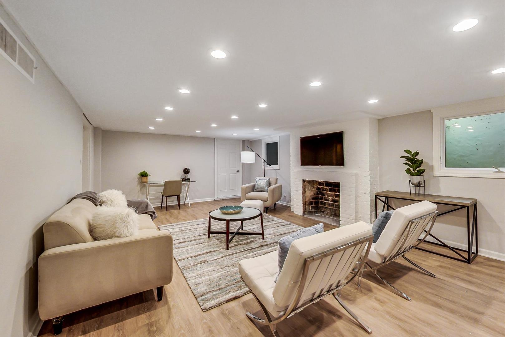 110 Sheridan Road Winnetka, IL 60093 - Photo 36 of 41 a living room with fireplace furniture and a flat screen tv