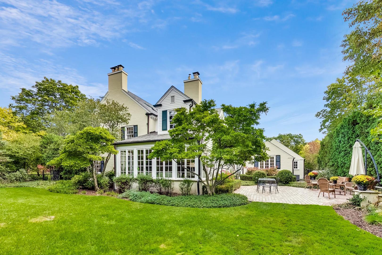 110 Sheridan Road Winnetka, IL 60093 - Photo 37 of 41 a front view of a house with a garden and plants