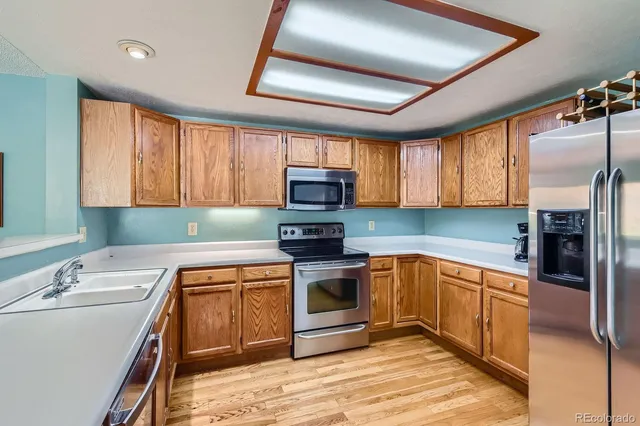 a kitchen with a sink appliances and cabinets
