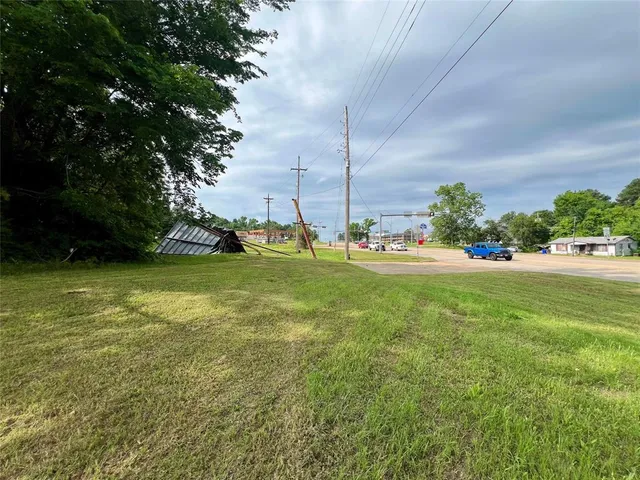 a view of yard with swimming pool and green space