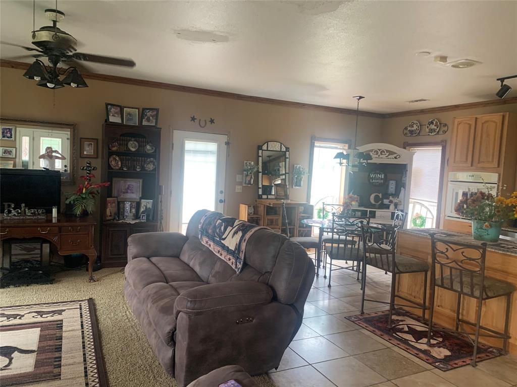 1980 Compass Way Bluff Dale, TX 76433 - Photo 8 of 16 a living room with furniture a flat screen tv and a dining table