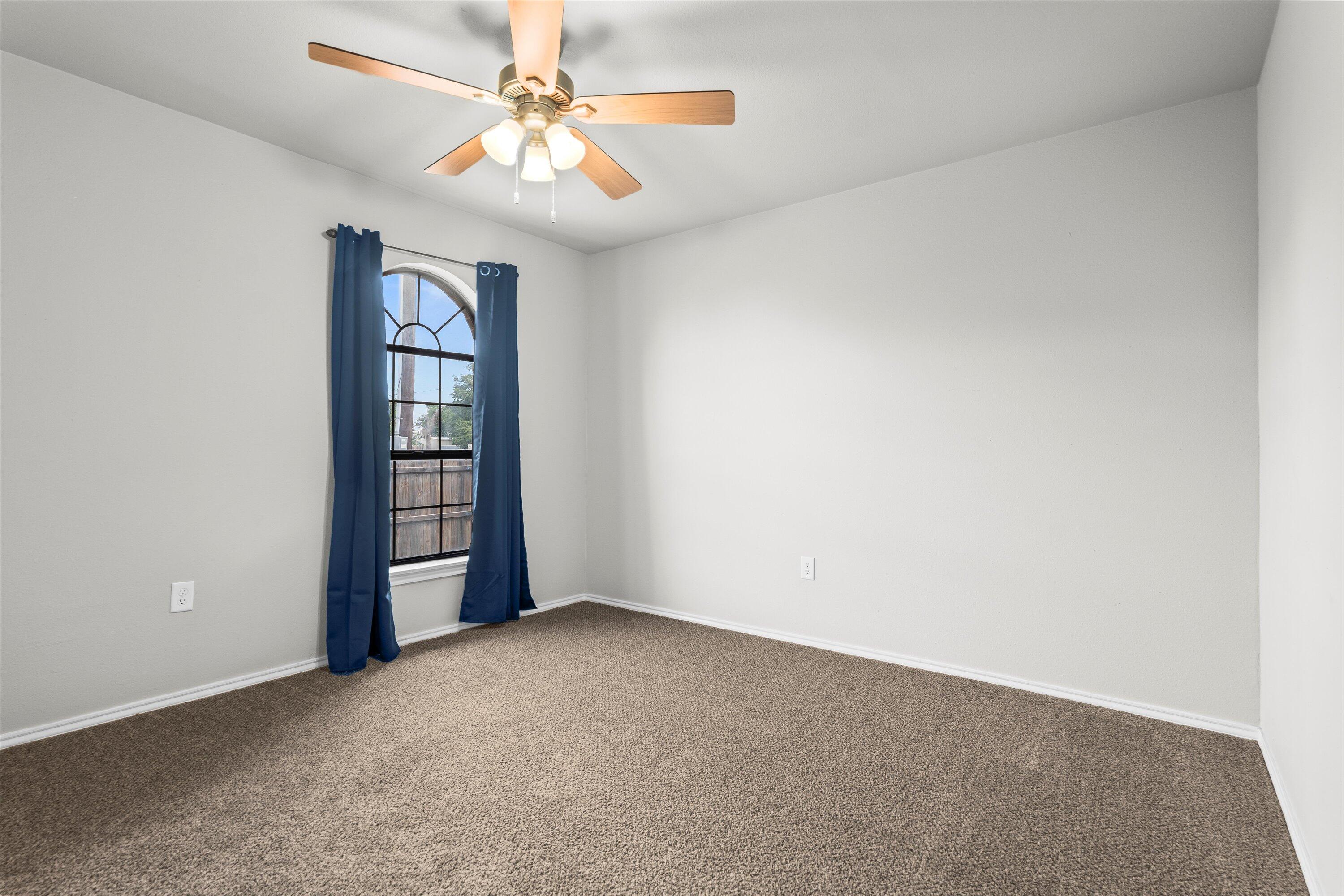 327 Hiracheta Drive New Home, TX 79381 - Photo 13 of 26 an empty room with windows and fan