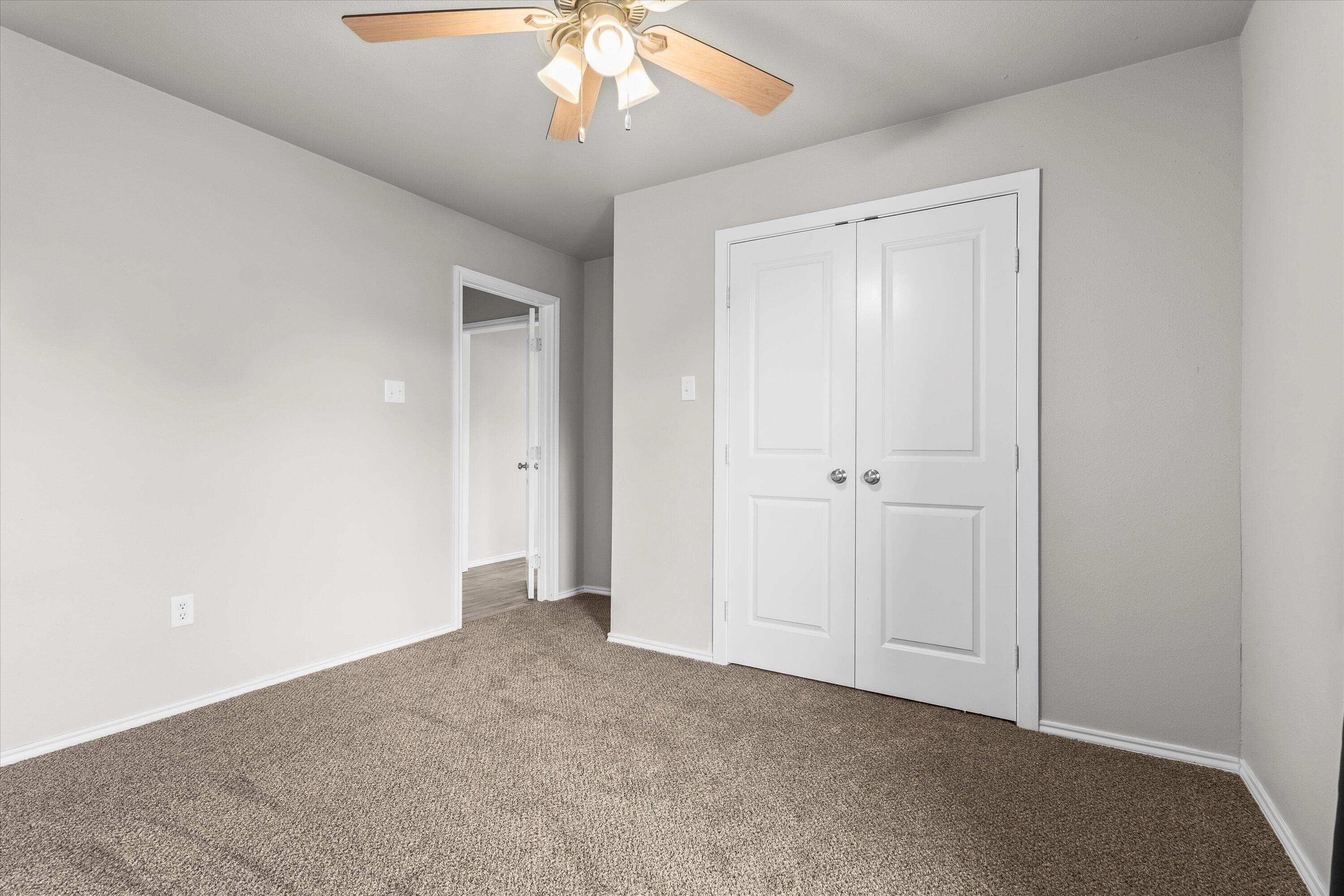 327 Hiracheta Drive New Home, TX 79381 - Photo 14 of 26 an empty room with a chandelier fan
