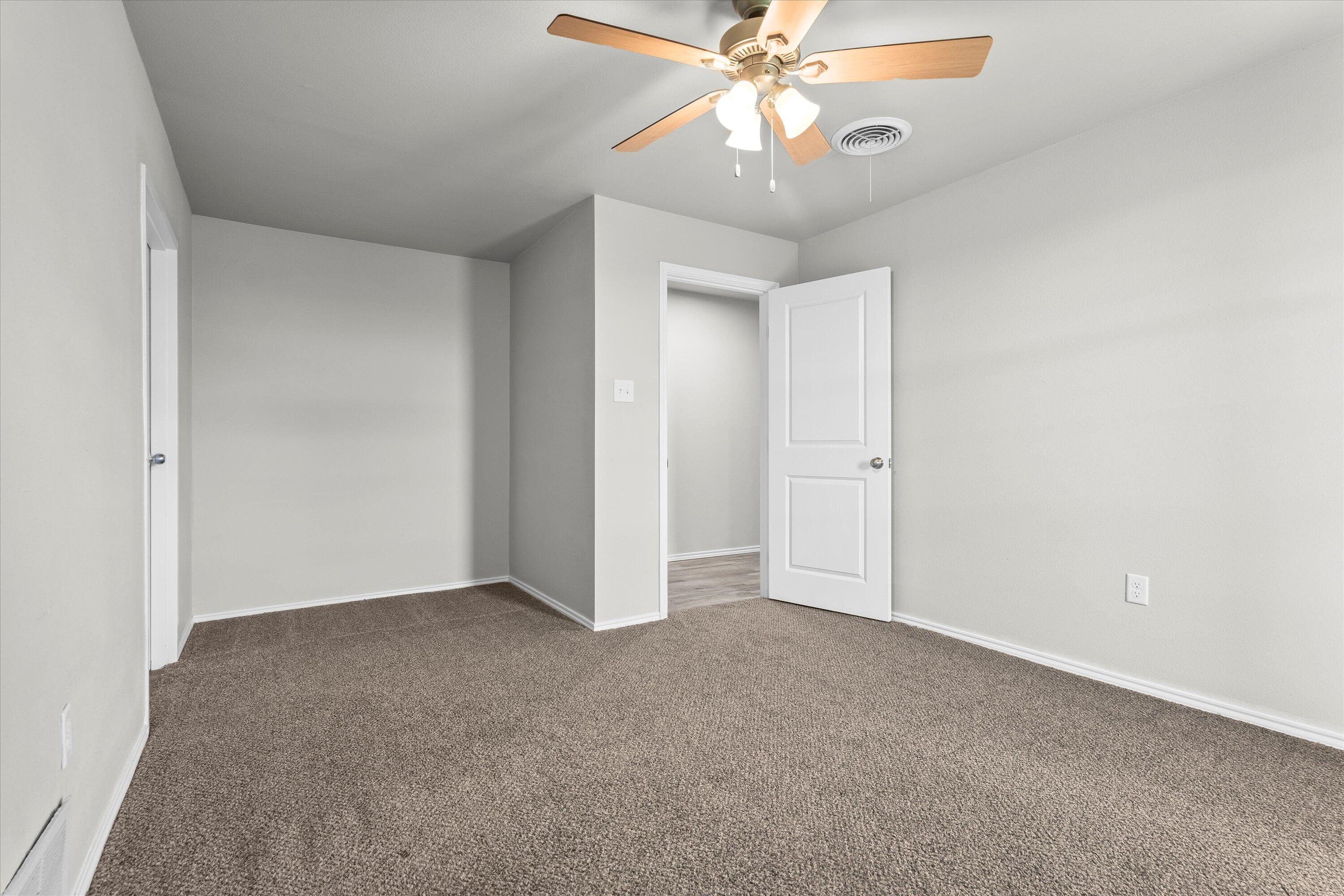 327 Hiracheta Drive New Home, TX 79381 - Photo 20 of 26 an empty room with closet and a chandelier fan