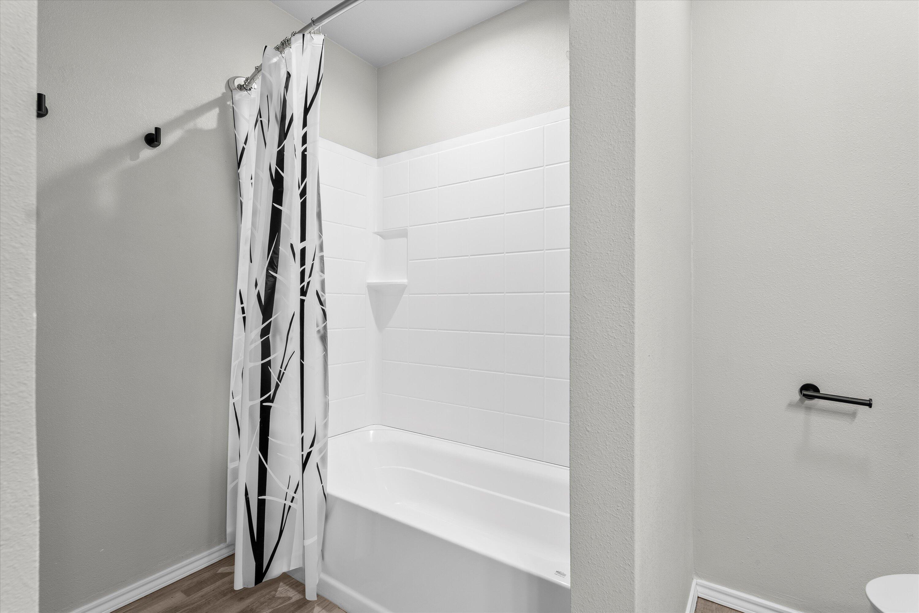 327 Hiracheta Drive New Home, TX 79381 - Photo 22 of 26 a bathroom with a bathtub and shower