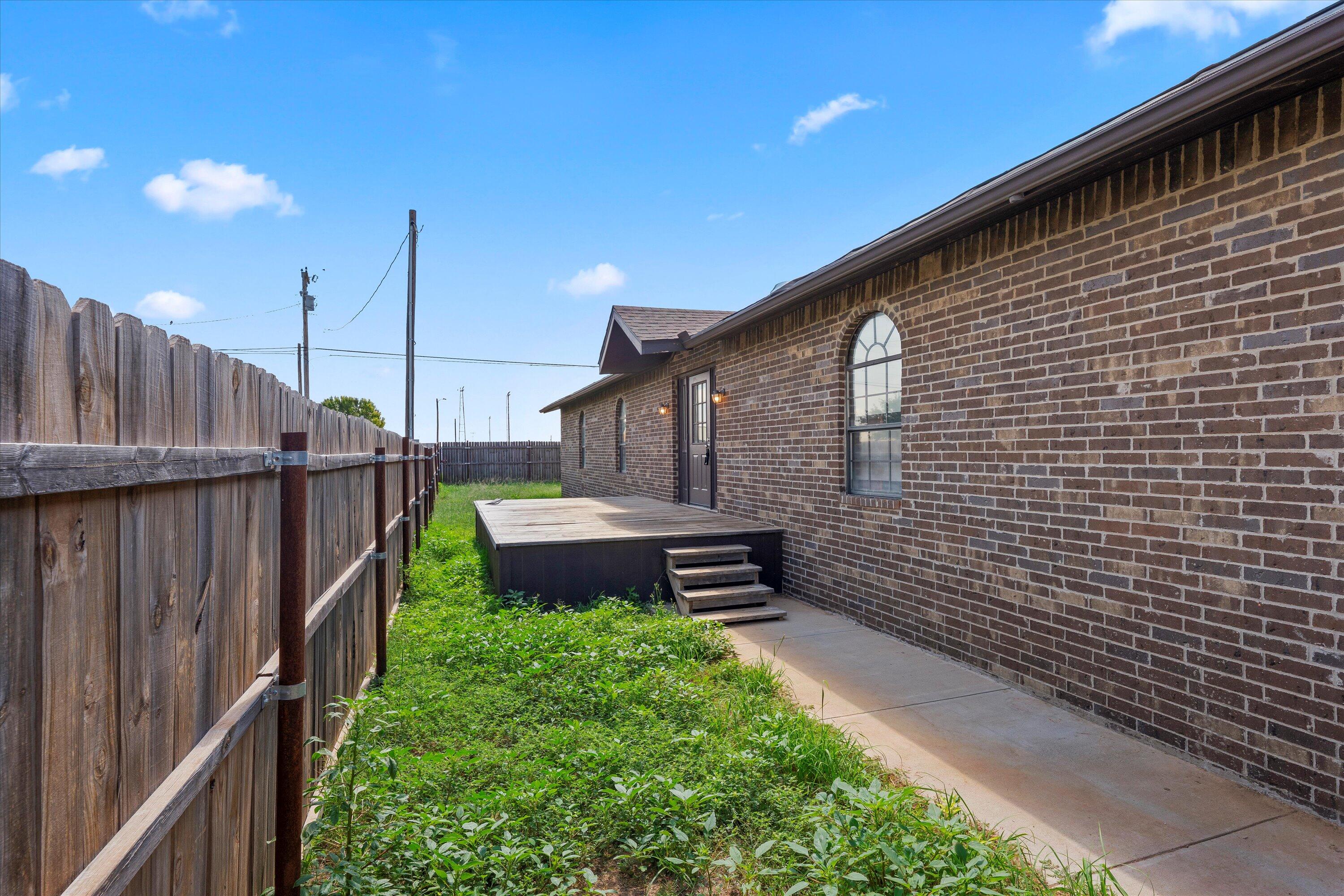 327 Hiracheta Drive New Home, TX 79381 - Photo 25 of 26 a backyard of a house with lots of green space