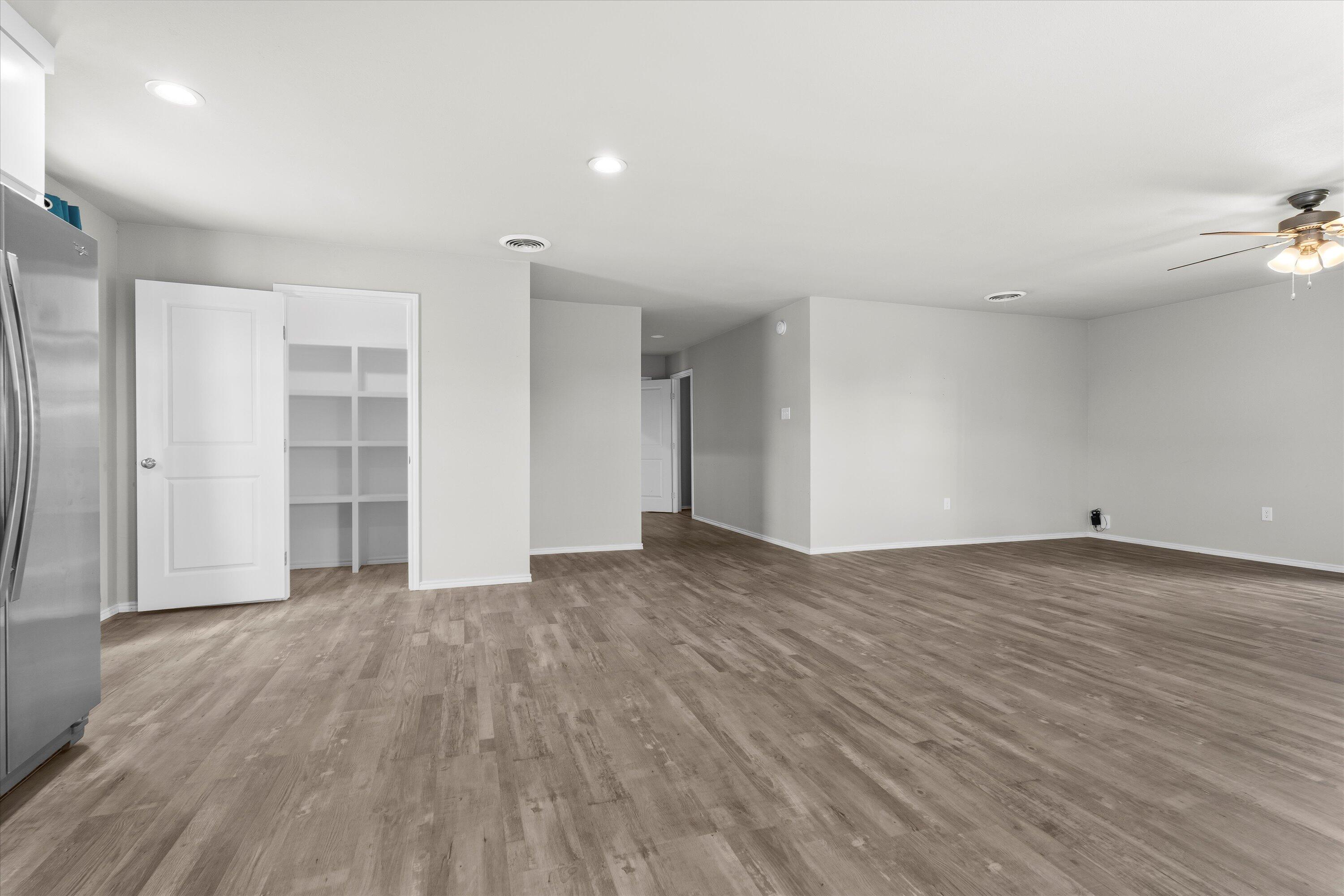 327 Hiracheta Drive New Home, TX 79381 - Photo 7 of 26 wooden floor in an empty room with a window