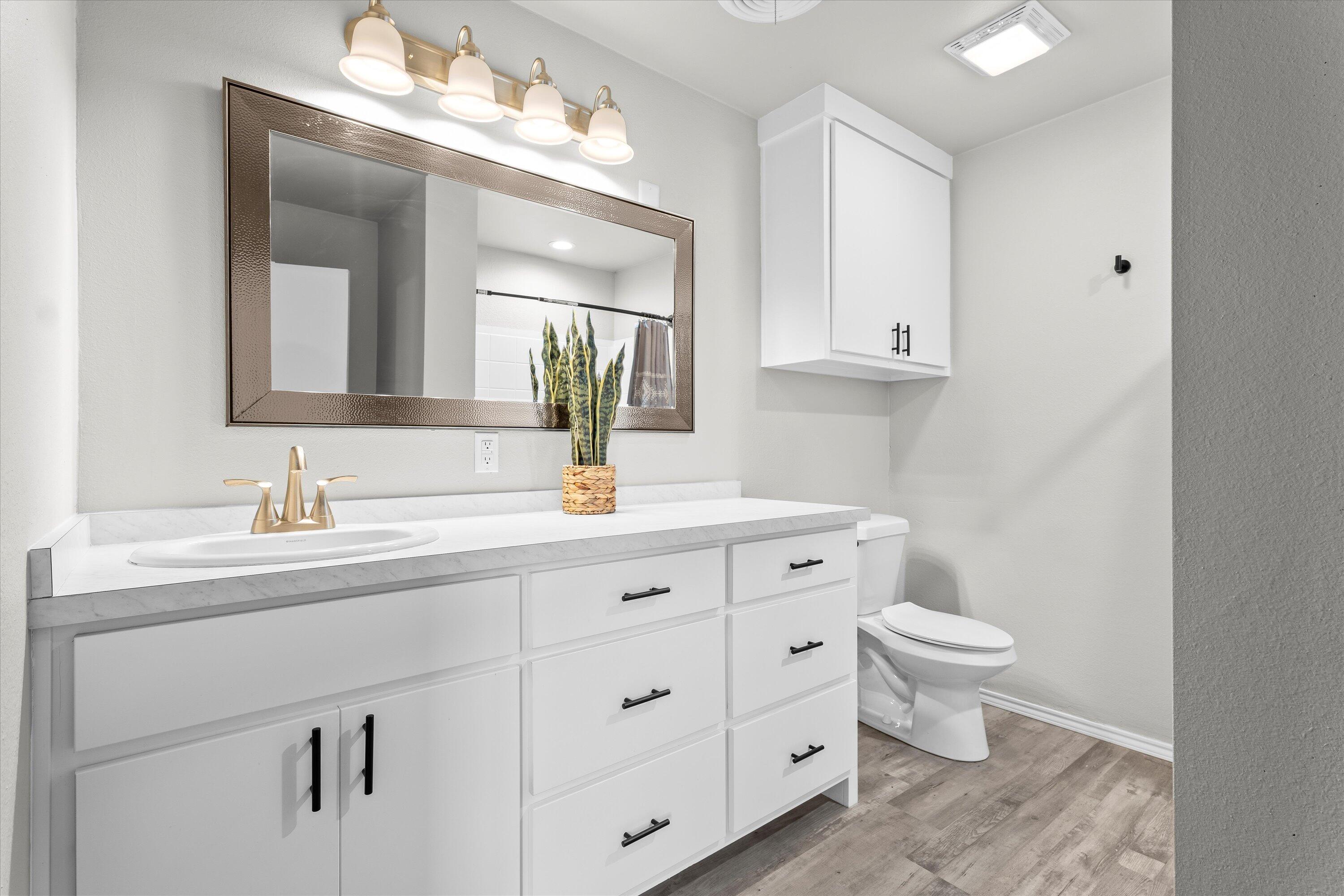 327 Hiracheta Drive New Home, TX 79381 - Photo 10 of 26 a bathroom with a toilet sink and mirror