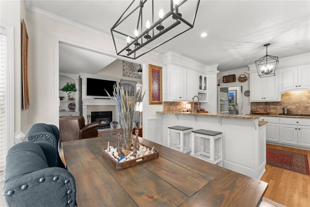 195 Sims Farm Way Maysville, GA 30558 - Photo 16 of 58 a living room with furniture a fireplace and a flat screen tv