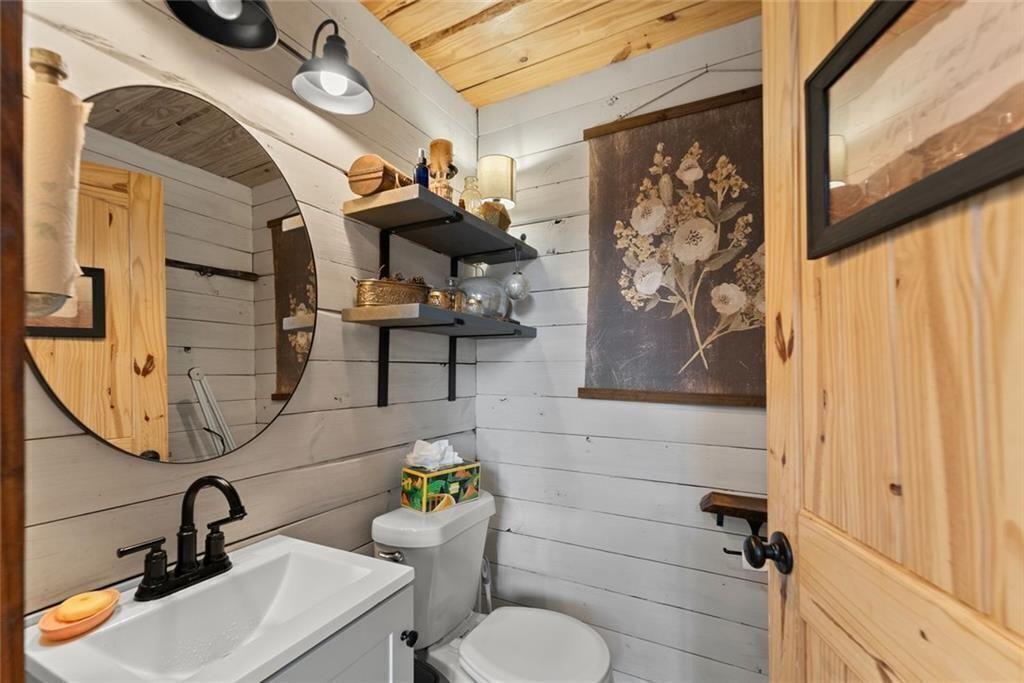 195 Sims Farm Way Maysville, GA 30558 - Photo 29 of 58 a bathroom with a toilet sink and mirror