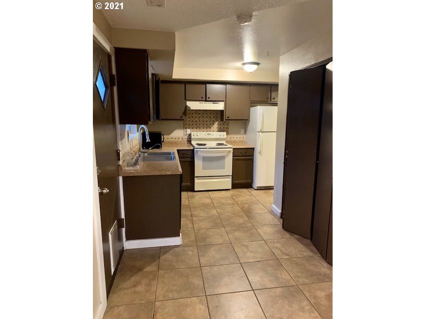 807 Southwest 14th Street Pendleton, OR 97801 - Photo 5 of 17 a kitchen with a sink and a refrigerator
