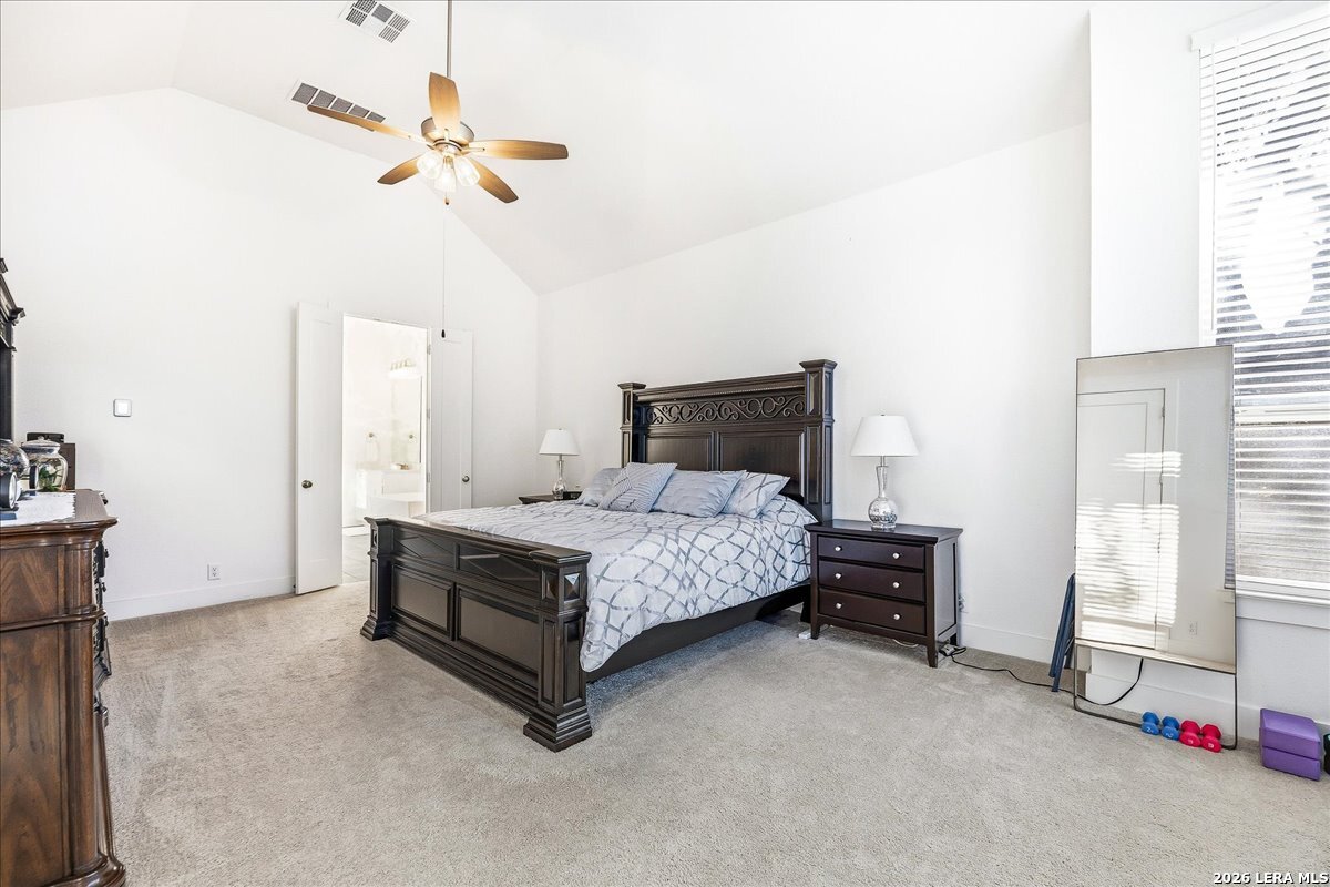 421 Corwin Springs Cibolo, TX 78108 - Photo 19 of 42 a bedroom with a bed and a chandelier