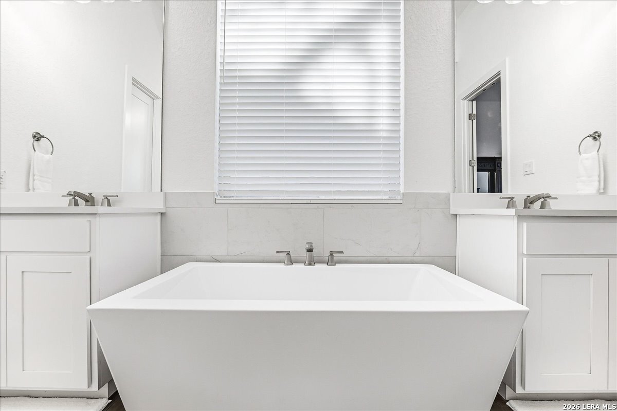 421 Corwin Springs Cibolo, TX 78108 - Photo 24 of 42 a bathroom with a sink and a mirror