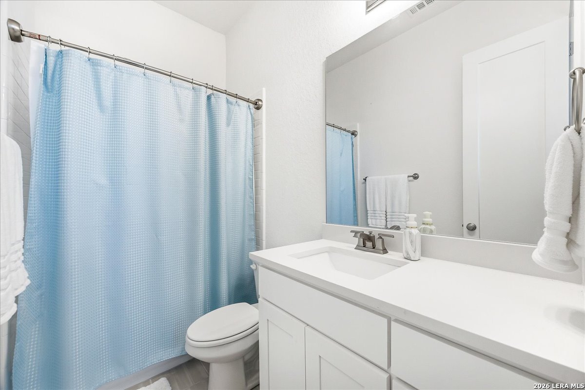 421 Corwin Springs Cibolo, TX 78108 - Photo 27 of 42 a bathroom with a sink a toilet and a mirror