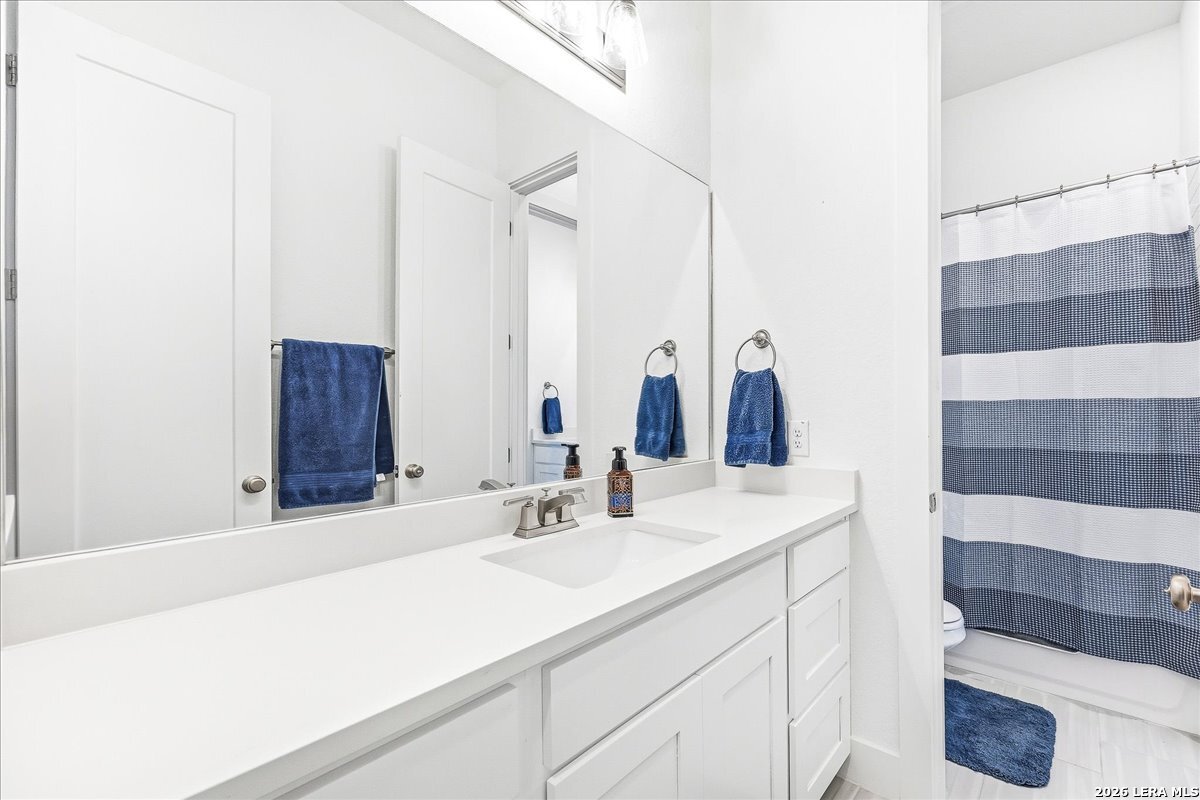 421 Corwin Springs Cibolo, TX 78108 - Photo 32 of 42 a bathroom with a sink and a mirror