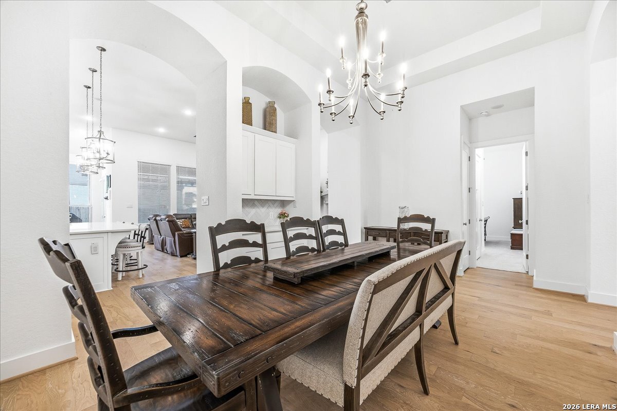 421 Corwin Springs Cibolo, TX 78108 - Photo 6 of 42 a view of a dining room with furniture and wooden floor