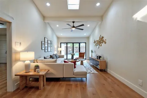 a living room with furniture a table and a large window