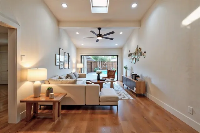 a living room with furniture a chandelier and a window