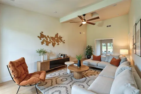 a living room with furniture and a chandelier