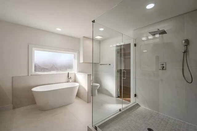 a bathroom with a bathtub and shower